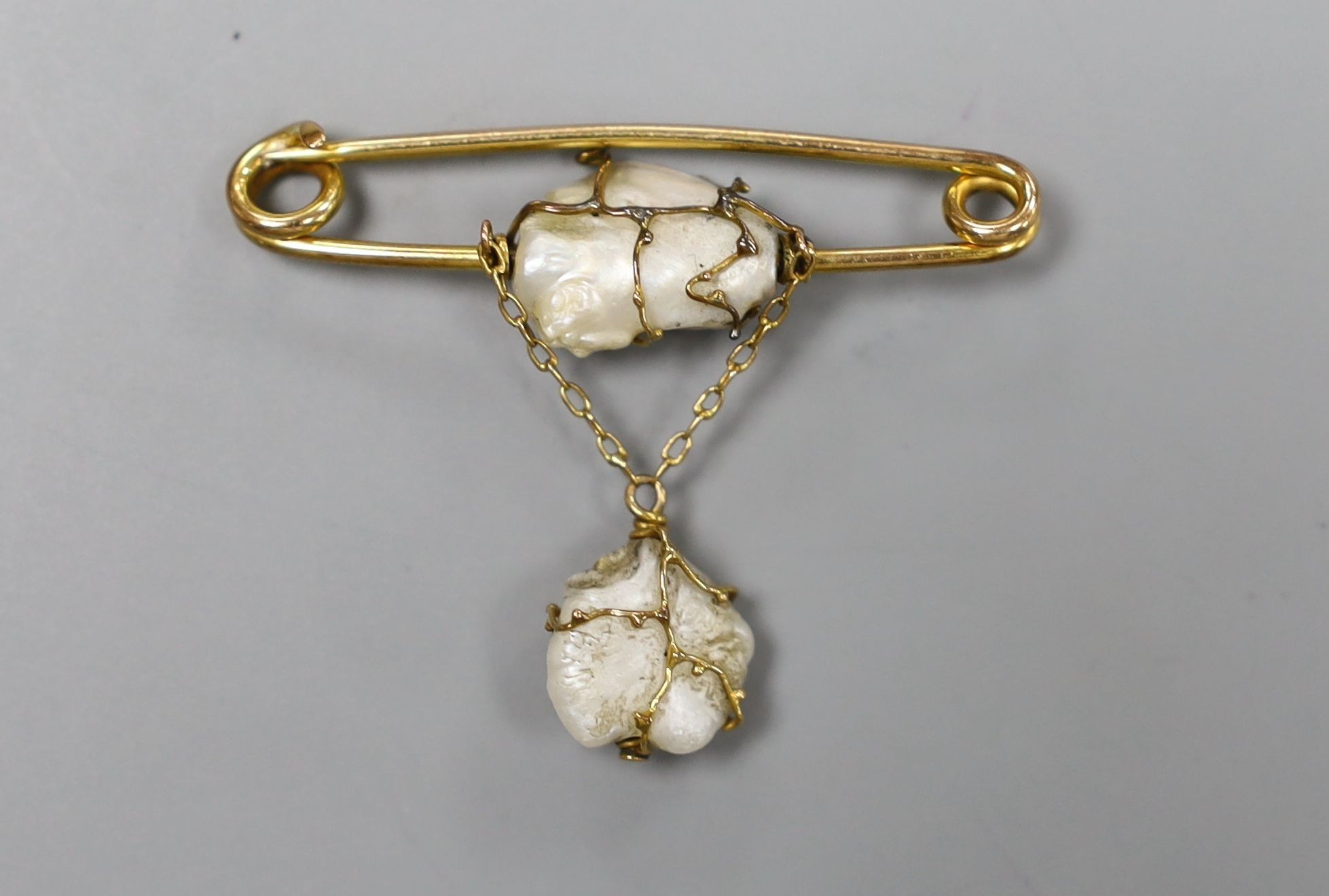 An early 20th century 9ct and two stone baroque pearl set drop brooch by Murrle Bennett & Co, width 4cm, gross 3.4 grams.